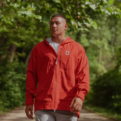 one model wears an ohio state jacket on a green background