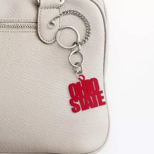 red ohio state bag charm on a white bag 