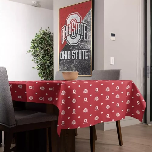 An Ohio State Buckeyes rectangular disposable plastic tablecloth featuring a red background patterned with white block 