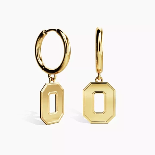 two gold huggie earrings with a block O charm 
