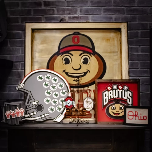 various ohio state licensed decor items lean against a gray brick background 