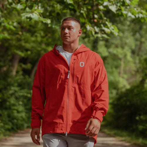 one model wears an ohio state jacket on a green background