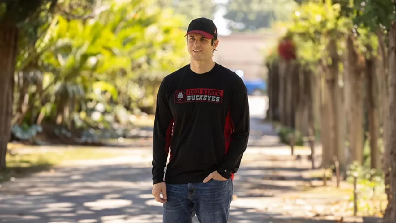 Model wearing black with red & gray details block letter 