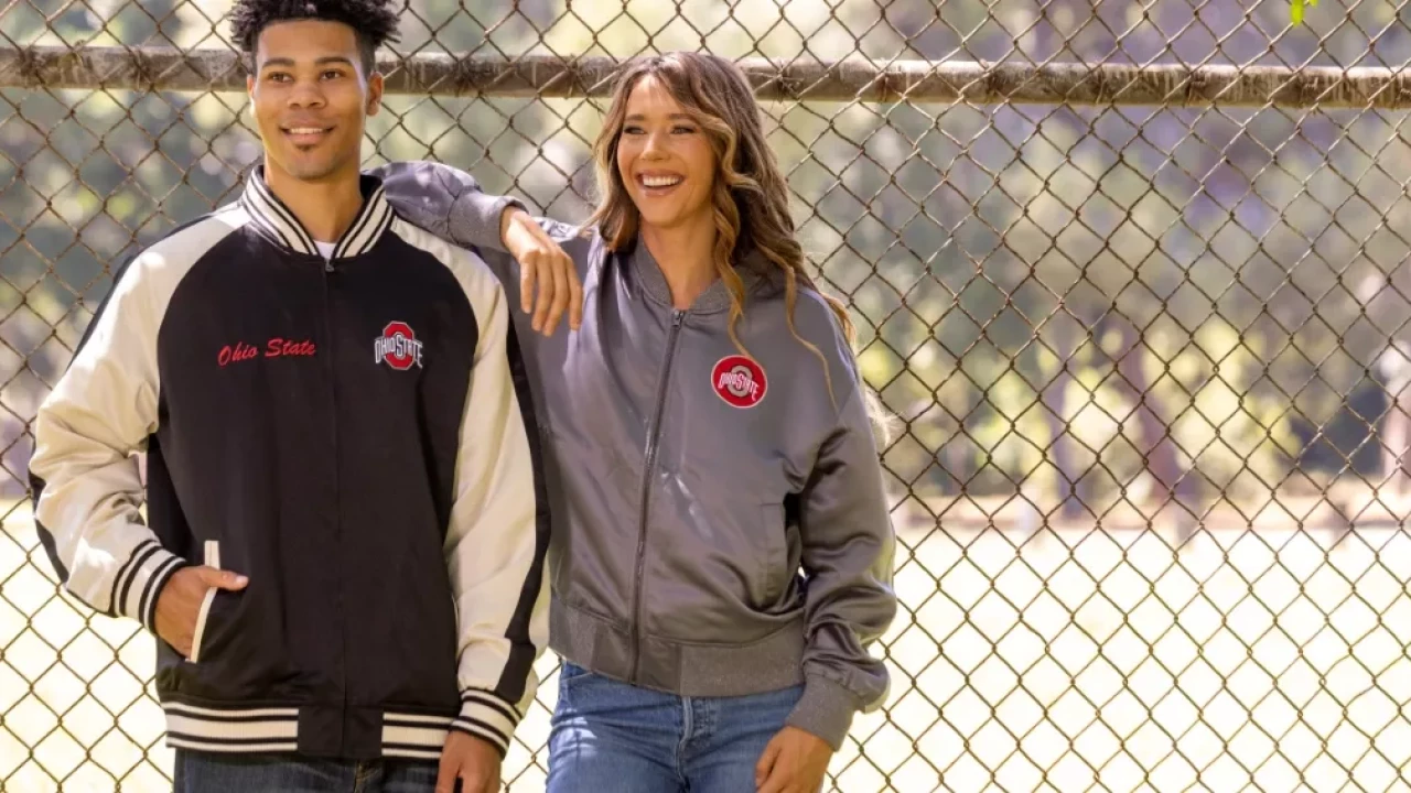 Model (left) is wearing a black body with cream sleeve wind breaker left breast 